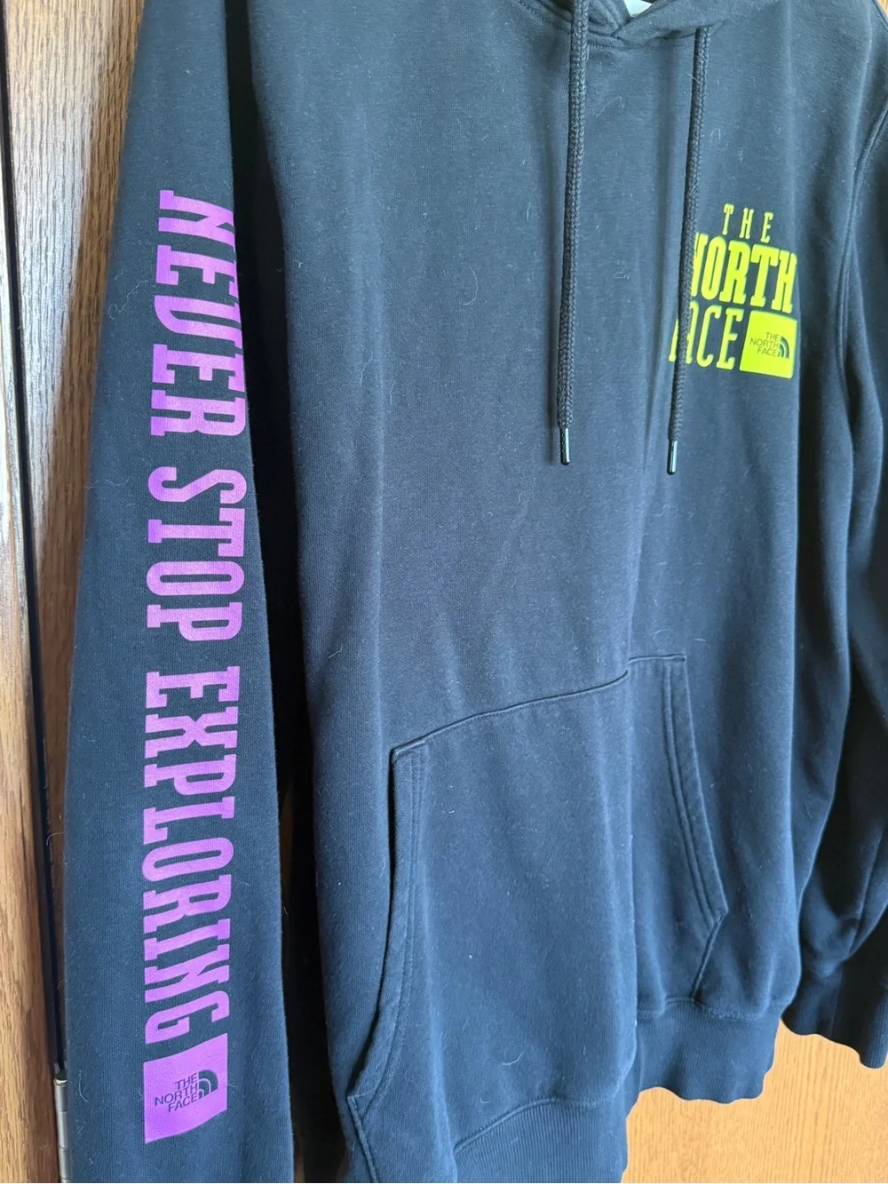 The North Face Black Hoodie with Yellow Chest Logo and Pink Sleeve Text